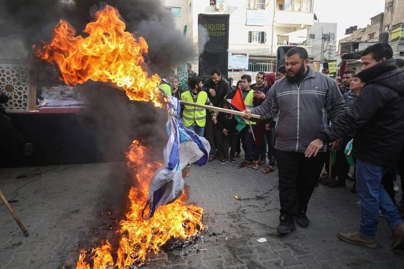 Palestinian protesters burn Israeli flags during a demonstration against US President Donald Trump's Middle East peace proposal in Khan Yunis in the southern Gaza Strip. AFP