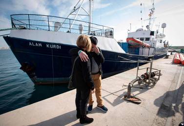 Abdullah Kurdi and his siter Tima react in front of a Sea-Eye rescue boat named after his son and her nephew Alan Kurdi during its inauguration in Palma de Mallorca on February 10, 2019. AFP