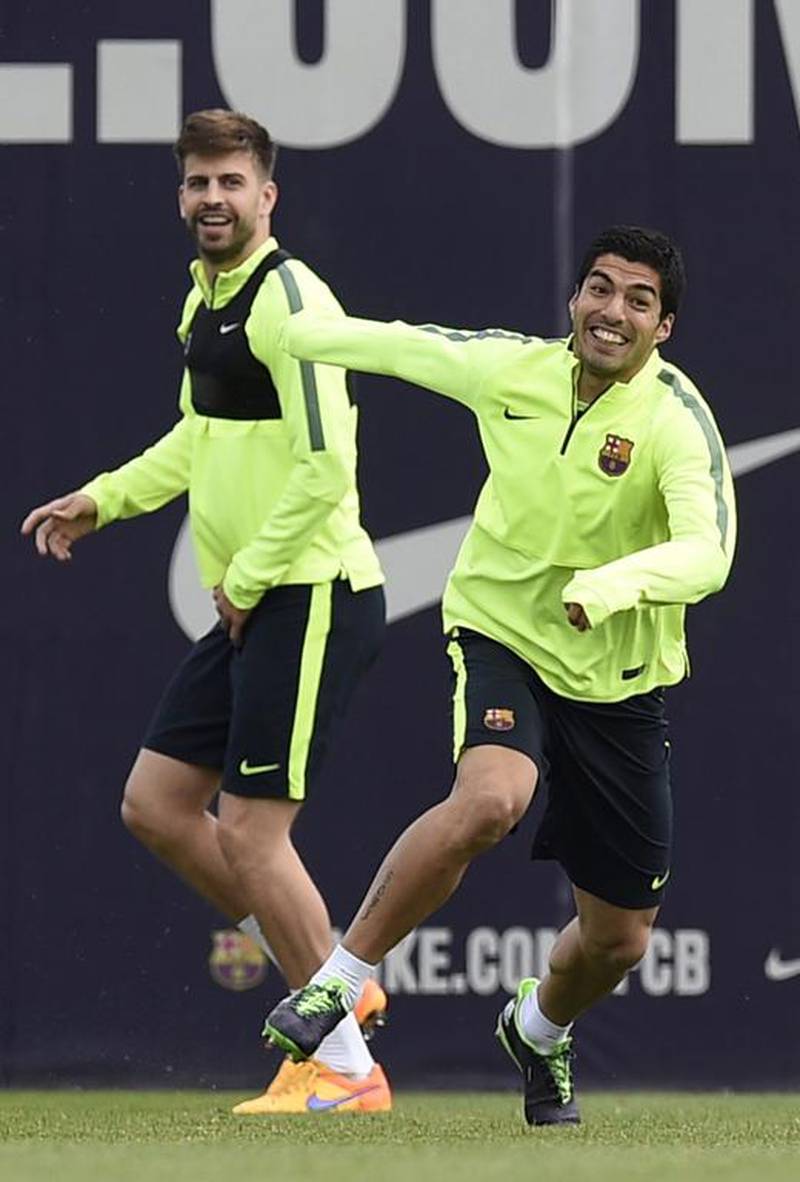Barcelona's Gerard Pique and Luis Suarez take part in the training session on Monday for the Champions League match against Paris Saint-Germain on  Tuesday. Lluis Gene / AFP
