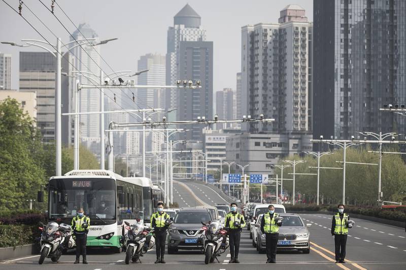 Police mourn while traffic stops during a silent tribute to martyrs who died in the fight against the novel coronavirus disease outbreak and compatriots who died of the disease on April 4,2020 in Wuhan, Hubei Province, China. Getty Images