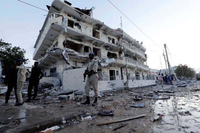 Security forces walk through rubble near damaged buildings after a suicide car bomb exploded, targeting a hotel in a business center in Maka Al Mukaram street, Mogadishu, Somalia March 1, 2019. REUTERS/Feisal Omar