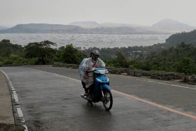 A motorcycles passes by the Taal volcano in Batangas.