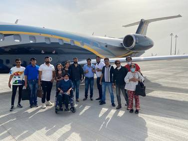 Dr Rahul Gupta (fourth from right) and Dr Rekha Singh (in a wheelchair) are among 13 UAE residents who returned from India recently on a business jet after incoming commercial flights were suspended from India. Courtesy: Dr Gupta