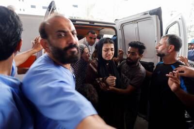 Wounded Palestinians are assisted out of an ambulance to receive treatment at Nasser Hospital in Khan Younis. Reuters