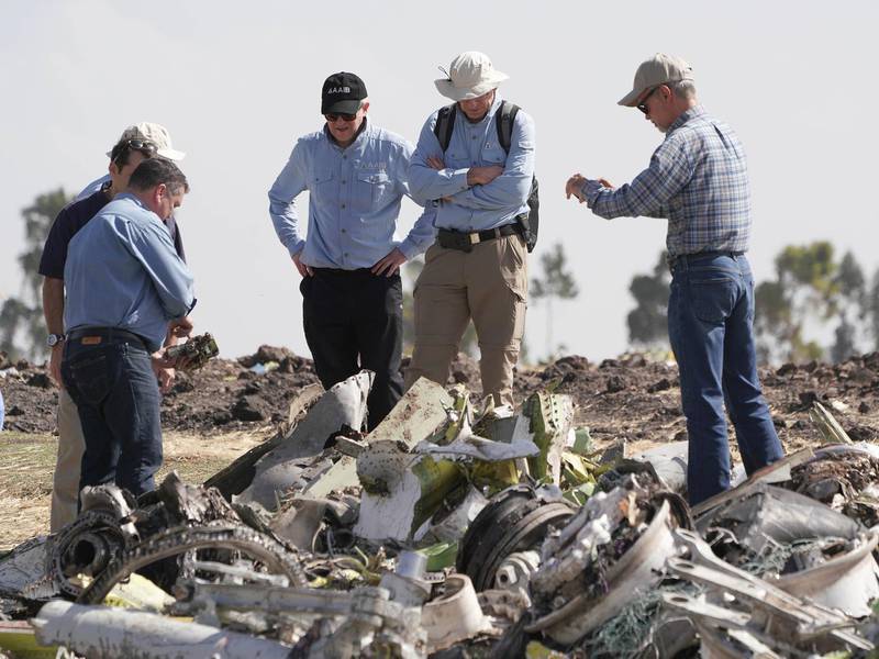 Investigators with the NTSB look over debris at the crash site. Getty Images