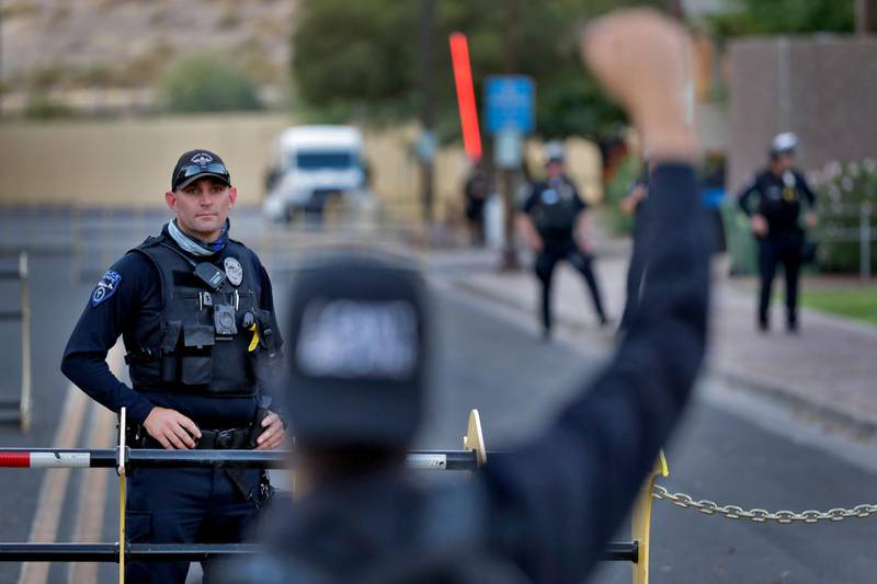 A protester confronts a Tempe police officer during a rally in Arizona. AP Photo