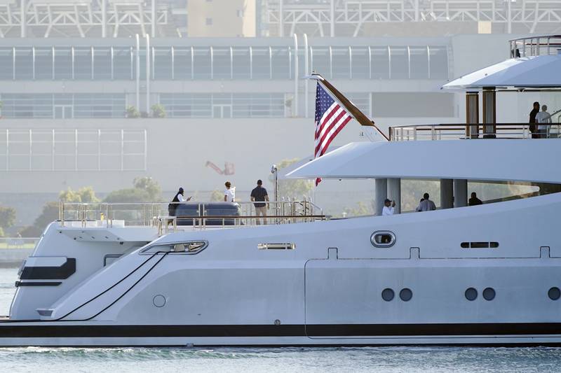 People look from the superyacht 'Amadea' as it arrives at San Diego Bay in California on Monday. AP