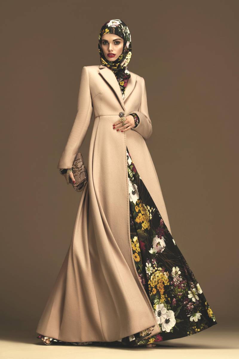 A nude ankle-length coat complements this floral maxi-dress and matching head covering
