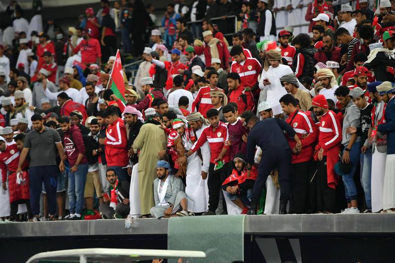 Omani fans stand behind a broken glass barrier at the end of the Gulf Cup of Nations 2017 final football match between Oman and the UAE at the Sheikh Jaber al-Ahmad Stadium in Kuwait City on January 5, 2018. Guiseppe Cacace / AFP