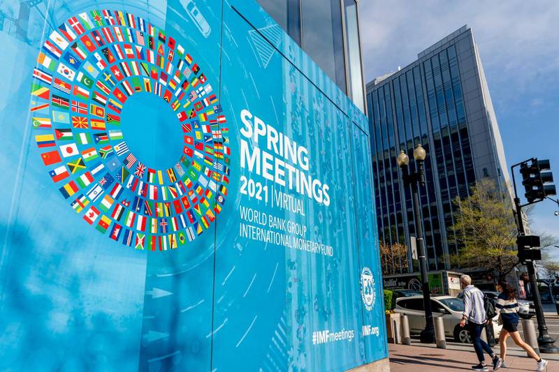 A poster is displayed on the International Monetary Fund building, Monday, April 5, 2021, in Washington. The IMF and the World Bank open their virtual spring meeting. (AP Photo/Andrew Harnik)