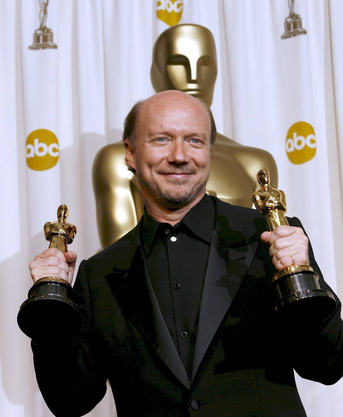 epa00660790 Director Paul Haggis holds his Oscars for 'Original Screenplay' and 'Best Picture of the Year' for the film 'Crash' at the 78th annual Academy Awards in Hollywood, California Sunday, 05 March 2006.  EPA/PAUL BUCK