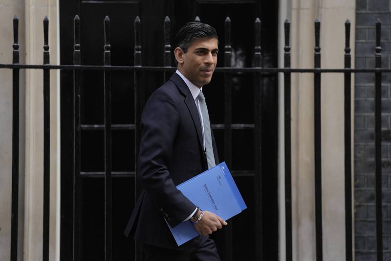 Rishi Sunak, Britain's Chancellor of the Exchequer, poses for the media as he leaves 11 Downing Street in London. AP