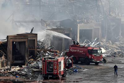 Firefighters extinguish a fire in a warehouse at the port of Beirut. EPA