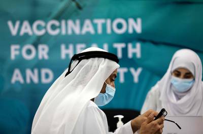 A man is registered before receiving a dose of vaccine at a centre in Dubai International Financial Centre. AFP
