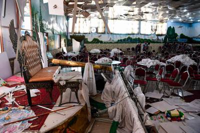 Afghan men investigate in a wedding hall after the deadly bomb blast. AFP