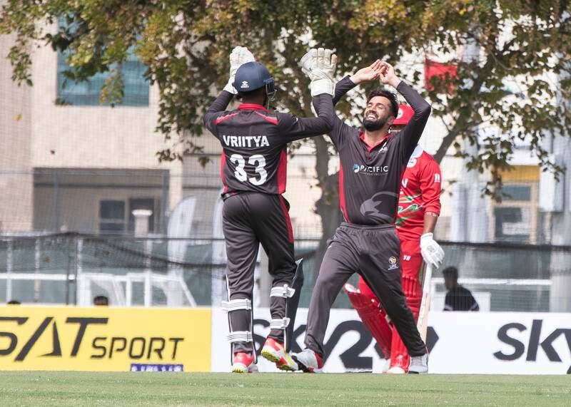 UAE players celebrate an Oman wicket during the Cricket World Cup League 2 match at the ICC Academy in Dubai. 