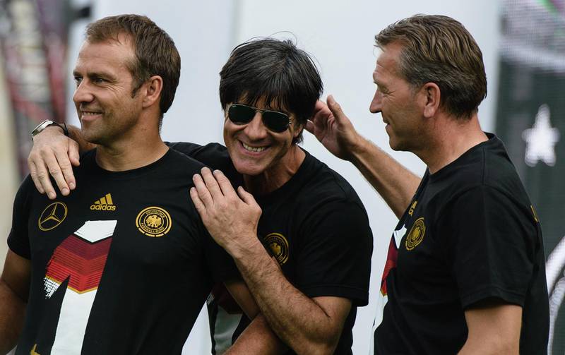 Left to right: Andreas Koepke, Joachim Low and Hansi Flick celebrating during a victory parade in Berlin after winning the 2014 World Cup. AFP