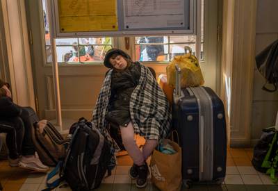 A girl sleeps as refugees from Ukraine wait at the railway station in Przemysl, Poland. More than half of Ukraine's children have already been displaced, Unicef said. AFP