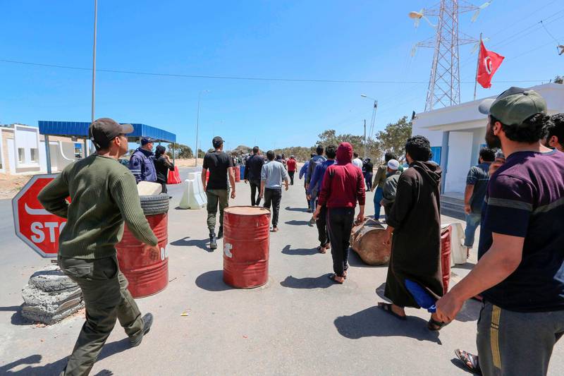 Tunisian workers stranded in Libya wait at the Ras Jedir border post to return to their country on April 21, 2020. AFP