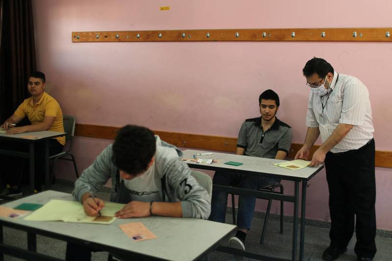 Palestinian students take high school exams in a classroom, amid concerns about the spread of coronavirus, in Gaza City. Reuters