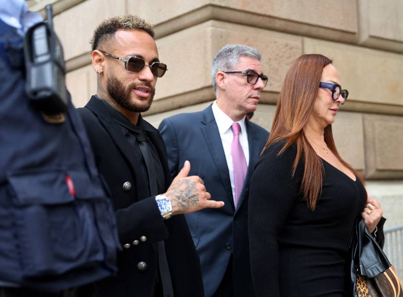 Neymar leaves court with his mother, Nadine Goncalves after standing trial on fraud and corruption charges. Reuters
