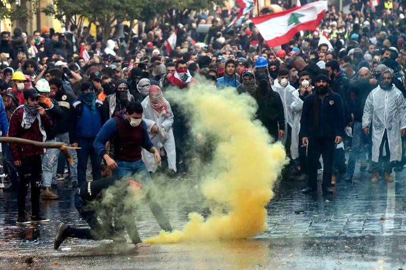 Anti-government protesters clash with Lebanese riot police outside of the Parliament in downtown Beirut.  EPA