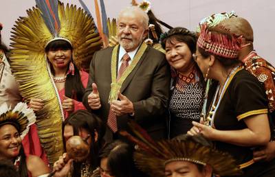 Brazilian president-elect Luiz Inacio Lula da Silva poses for a group photograph with  representatives of his country's indigenous people. AFP