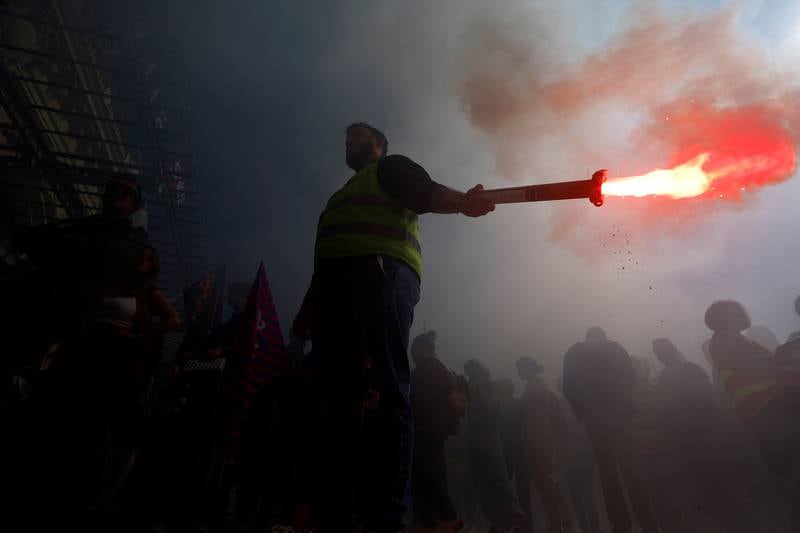 A striking worker brandishes a flare in Nice. Reuters