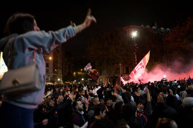 Supporters celebrate with flares and flags outside the stadium in Paris. AFP