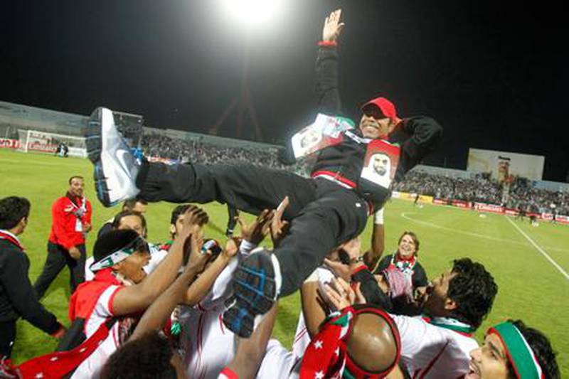 UAE coach Mahdi Ali celebrates with his players after their Gulf Cup victory over Iraq.