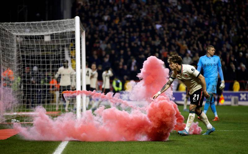 Kostas Tsimikas is startled by a flare thrown on to the pitch during Liverpool's FA Cup quarter-final match against Nottingham Forest. Reuters