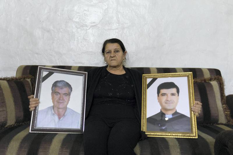 Mrs Bedoyan, the mother of the priest, pose with pictures of her son and her late husband. December 18, 2019. Thibault Lefébure for The National.