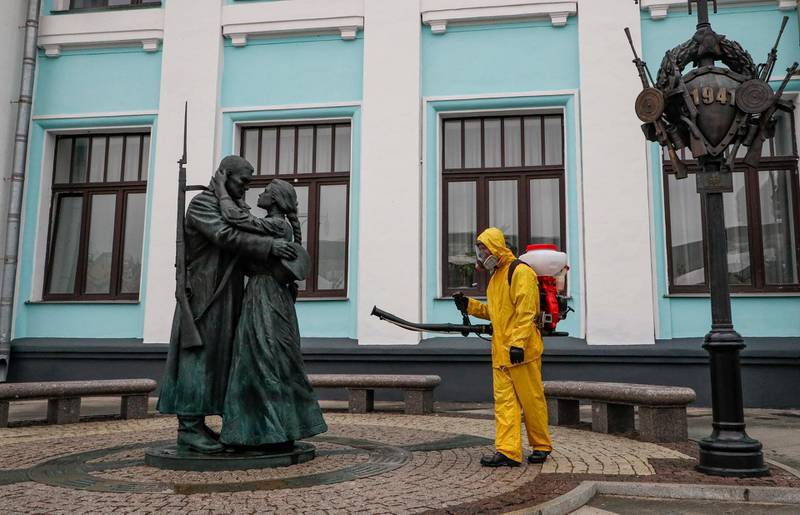 A Russian worker disinfects a monument to 'Farewell of Slavianka', a patriotic march by composer Vasily Agapkin, at Belorussky railway station in Moscow. Covid-19 infections have been rising in the country. EPA