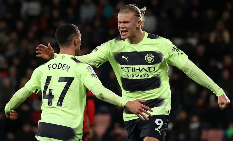 Manchester City's English midfielder Phil Foden (L) celebrates scoring his team's third goal with Norwegian striker Erling Haaland (R) during the English Premier League football match against Bournemouth. AFP.