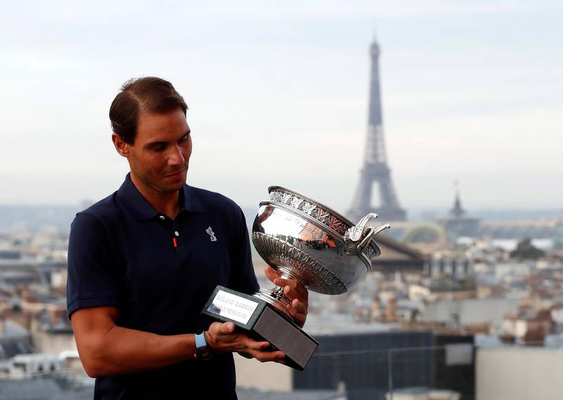 Rafael Nadal inspects the trophy.