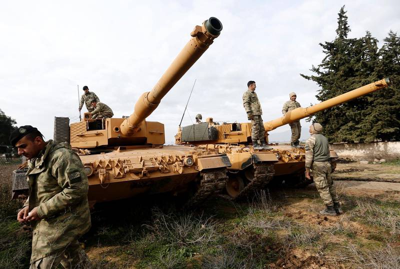 epaselect epa06459994 Turkish soldiers prepare their tanks near the Syrian-Turkish border, at Reyhanli district in Hatay, Turkey, 21 January 2018. Reports state that the Turkish army is on an operation (named 'Operation Olive Branch') in Syria's northern regions against the Kurdish Popular Protection Units (YPG) forces which control the city of Afrin. According to YPG media channels, bombings by the Turkish military killed at least 10 people earlier on the same day. Turkey classifies the YPG as a terrorist organization.  EPA/SEDAT SUNA