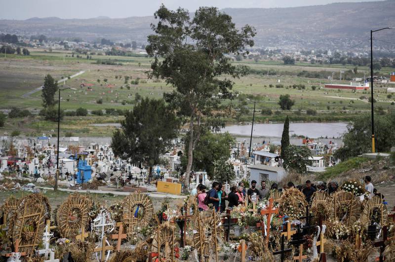 Relatives and friends stand near the coffin of a woman, who died of the coronavirus disease, during her funeral at the Xico cemetery in Valle de Chalco, in the State of Mexico, Mexico. Reuters