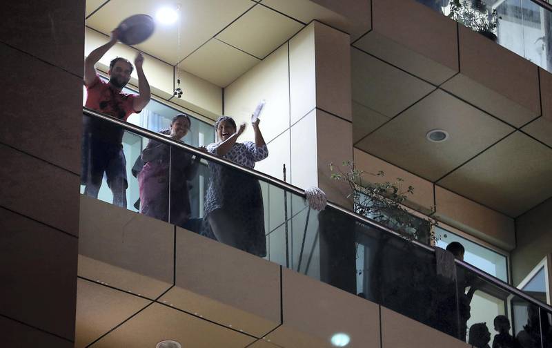 DUBAI, UNITED ARAB EMIRATES , March 25 – 2020 :- UAE residents cheering from their balconies and homes on Wednesday night at Al Mankhool area in Bur Dubai for doctors and medical staff for their tireless efforts in these critical times in Dubai. (Pawan Singh / The National) For News/Online/Standalone/Instagram