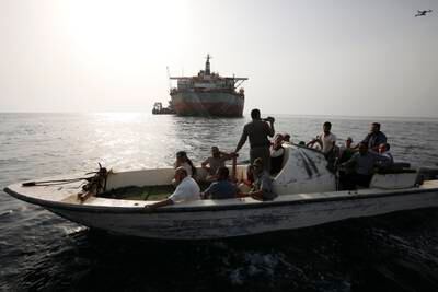 A boat of the Houthis-held coast guard drives past the FSO Safer oil tanker