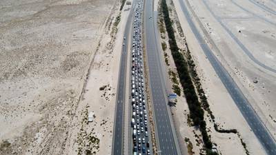 A picture taken with a drone shows cars queueing before a security checkpoint on the E11 highway, between Dubai and Abu Dhabi, in Dubai, United Arab Emirates.  EPA