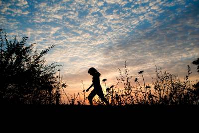 Palestinian children play in a field at sunset in Gaza City. AFP