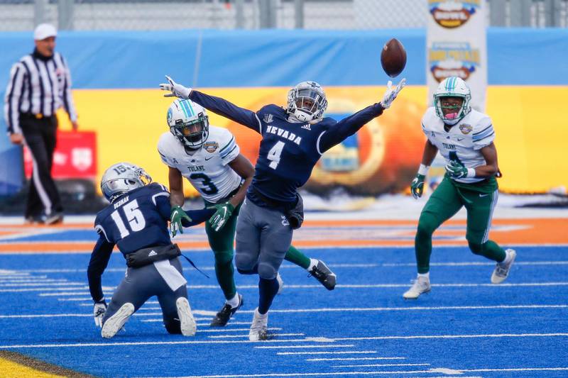 Nevada defensive back EJ Muhammad (4) reaches for the ball after it was tipped into the air from a pass by Tulane during the first half of the Idaho Potato Bowl NCAA college football game, in Boise, Idaho. Nevada intercepted the ball on the play. AP Photo