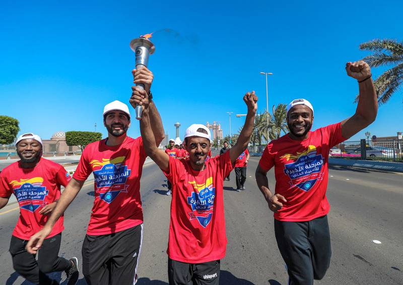 Abu Dhabi, UAE.  March, 14, 2018.  Law Enforcement Torch Run.  From the Heritage Flag to ADNOC. (center) Mohammed Khamis proudly carries the torch.Victor Besa / The National