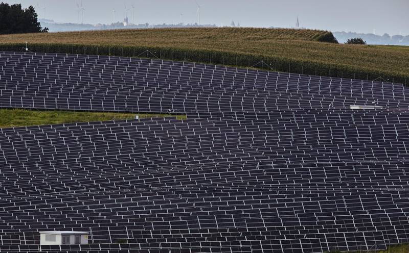 Solar panels on a hillside. For the first six months of this year, corporate procurement of clean energy stopped short of 15 gigawatts, less than half of last year’s total. Bloomberg