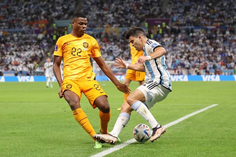 Dutch defender Denzel Dumfries fouls Marcos Acuna of Argentina in the box which leads to an Argentina penalty. Getty