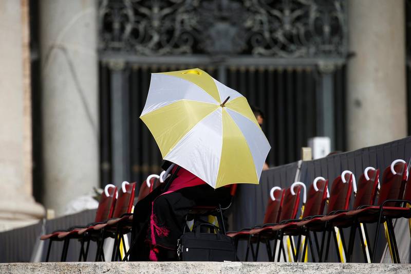 A member of the clergy holds an umbrella ahead of the general audience in St Peter's Square, at the Vatican. Reuters