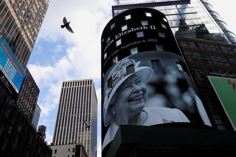 A bird flies by as a tribute to Queen Elizabeth appears on the screen of the Nasdaq MarketSite billboard in Times Square in New York. Reuters