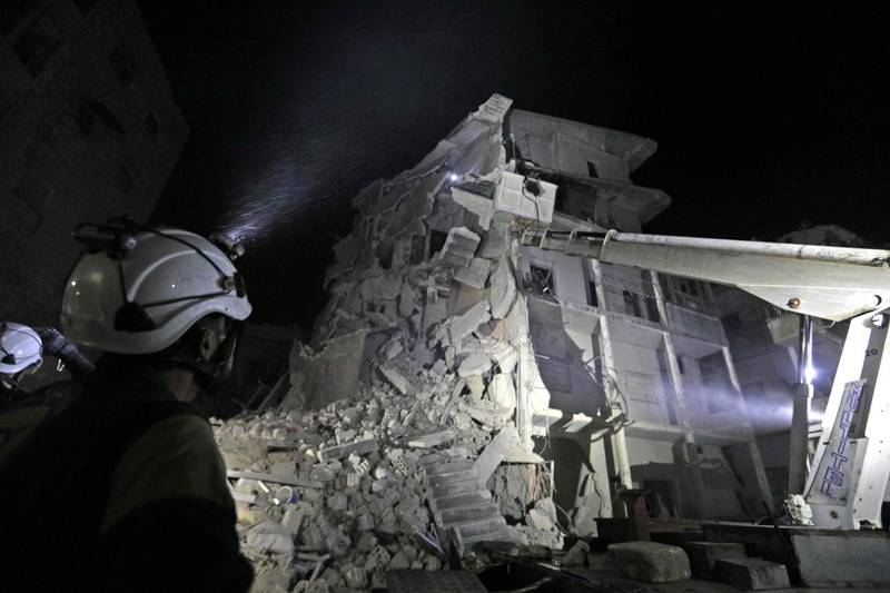 EDITORS NOTE: Graphic content / Members of the Syrian Civil Defence (White Helmets) search for victims as a building collapsed days after a reported air strike on the town of Ariha, in the south of Syria's Idlib province on July 31, 2019.  / AFP / Omar HAJ KADOUR
