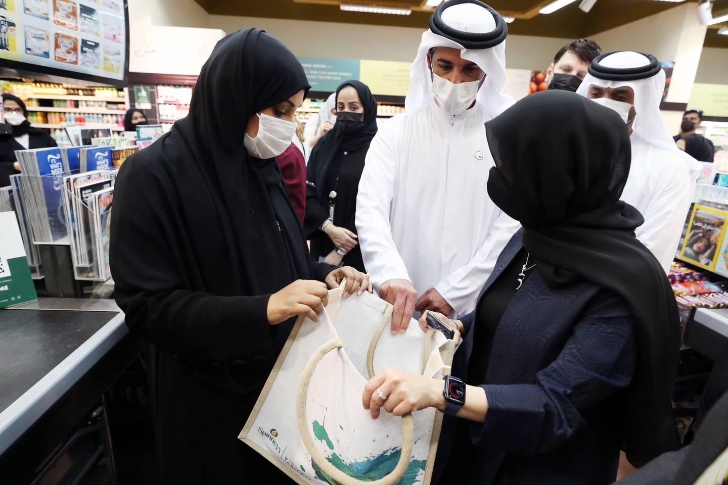 From June 1, Abu Dhabi will ban the use of single-use plastic bags. Shaikha Salem Al Dhaheri, in white mask, EAD's secretary general, on a visit to Spinneys, Muroor Road, Abu Dhabi. Chris Whiteoak / The National