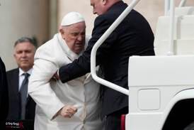 Pope Francis was helped to get on his car at the end of the weekly general audience in St Peter's Square at the Vatican on Wednesday. AP